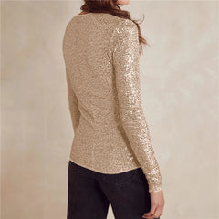 Gold sequin long-sleeve top worn by a person