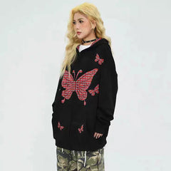 Person wearing a black hoodie with pink butterfly designs 