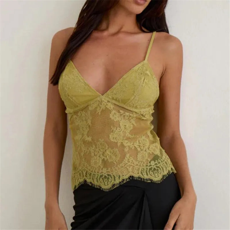 Woman wearing a yellow lace camisole against a plain background