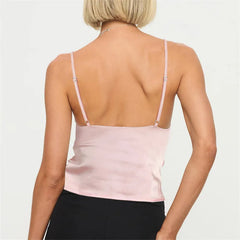 Person wearing a light pink spaghetti strap top 