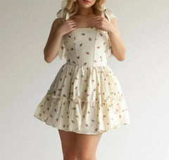 A woman wearing a stylish strawberry print mini dress with a flattering fit and a summery vibe.