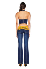 Woman wearing a denim outfit with a visible brand logo on a white background
