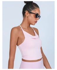 Woman wearing a light pink sports bra and leggings - side view