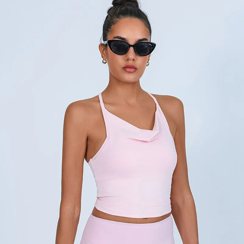 Woman wearing a pink one-shoulder top and sunglasses- close-up