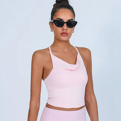 Woman wearing a pink one-shoulder top and sunglasses- close-up