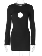 Close-up of the circle cut-out and long sleeves on a fashionable black mini dress.