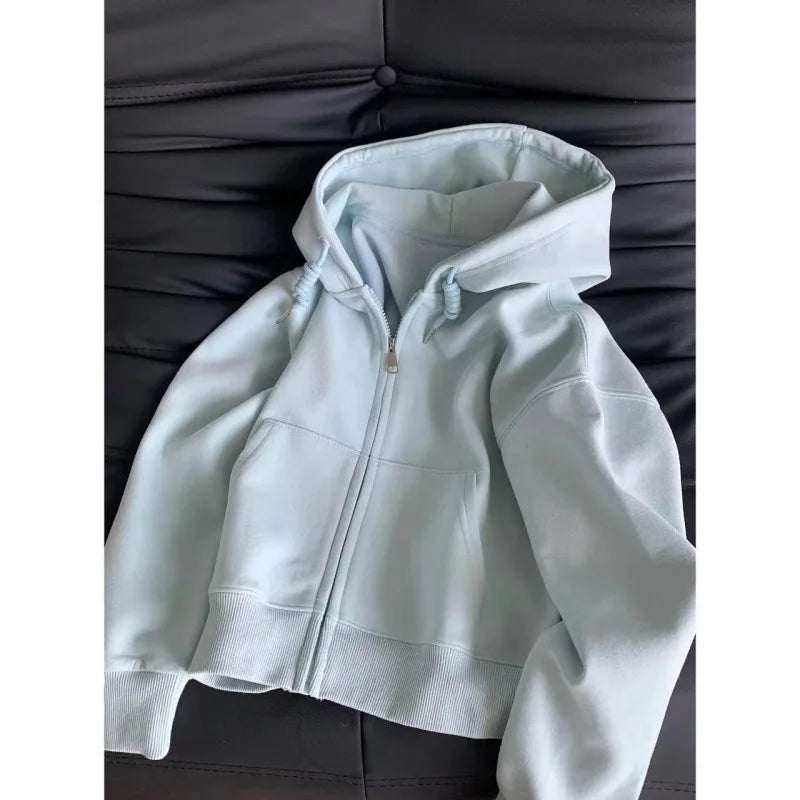 Light blue hoodie on a dark gray couch