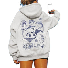 Person wearing a gray hoodie with marine animal illustrations on the back.