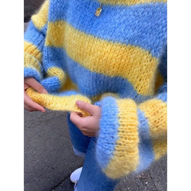 Close-up of a blue and yellow striped sweater with a person wearing it.