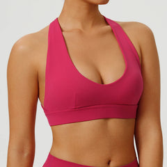 Pink sports bra worn by a person on a light gray background