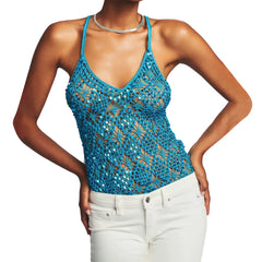Woman wearing a blue crochet tank top and white pants- front