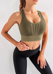 A stylish army green athletic top, showing the unique back detail.