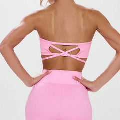 A matching pink workout outfit featuring a off-shoulder top and high-waisted shorts.