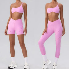 A matching pink workout outfit featuring a one-shoulder top and high-waisted shorts.