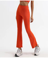 A woman wearing seamless flare leggings in a bright orange color.