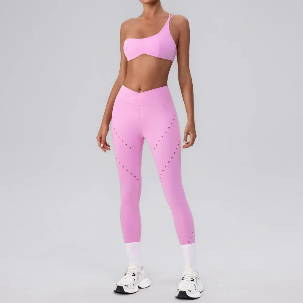 A woman wearing a pink seamless one-shoulder athletic set.