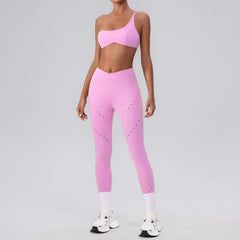 A woman wearing a pink seamless one-shoulder athletic set.