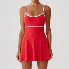 A sleeveless red tennis outfit styled with white sneakers.