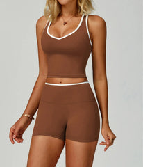 A woman wearing a brown athletic shorts and crop top set.
